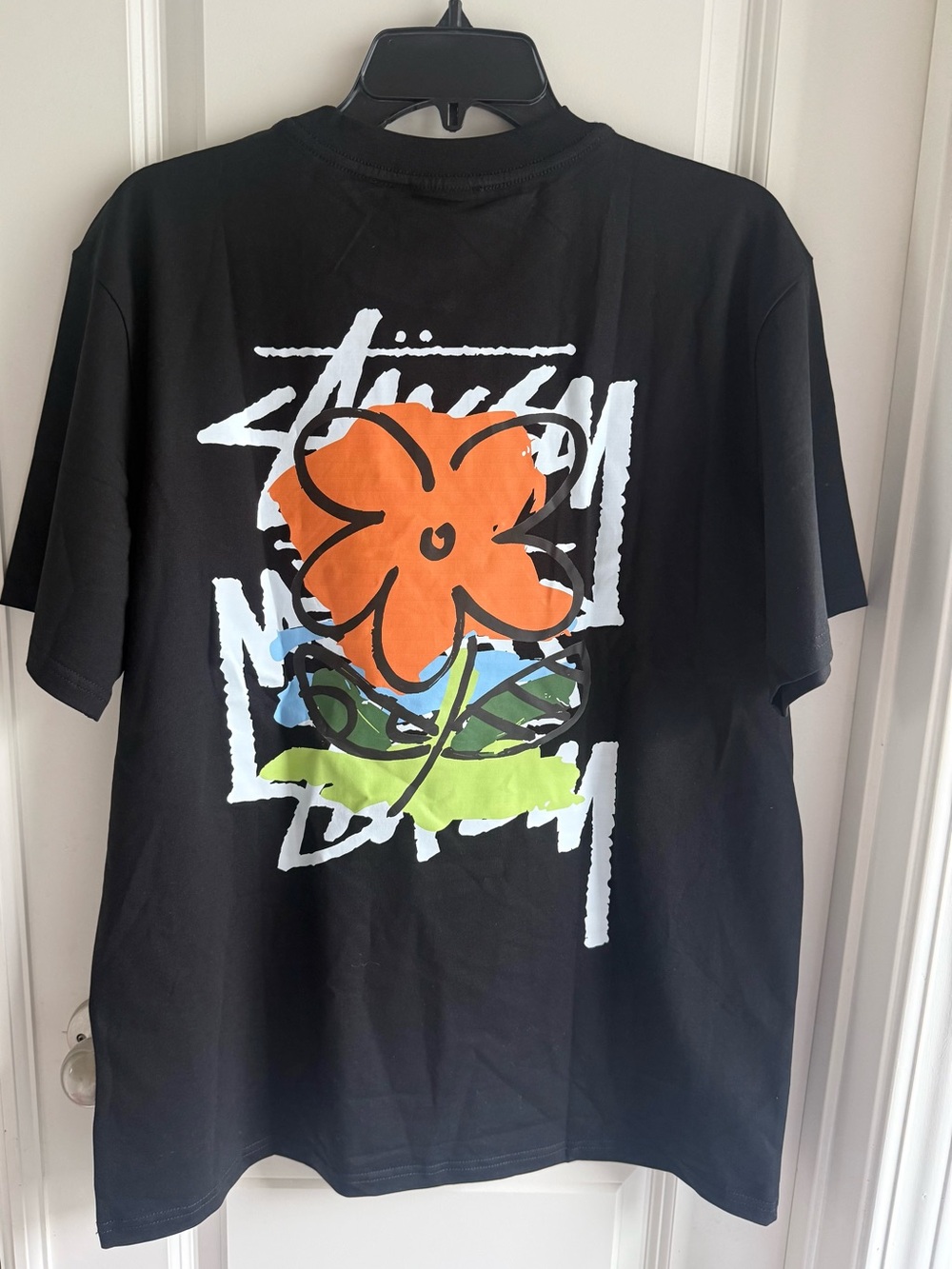 Stussy Black Tee with Orange Floral Graphic